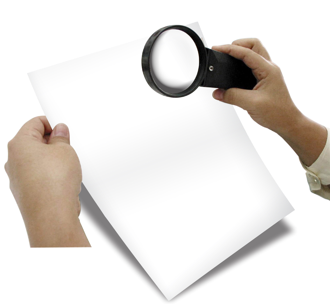 hands holding paper and magnifying glass